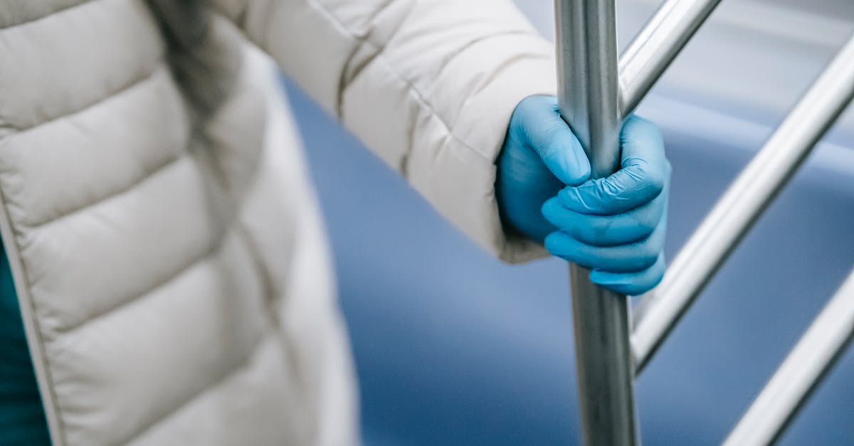 How can I prevent my hero from auto-attacking? - Crop unrecognizable person grasping handle in metro train