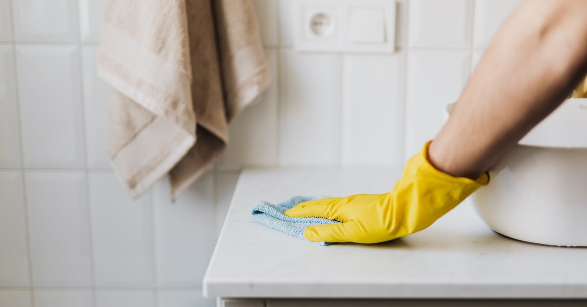 How can I protect my home? - Crop housewife cleaning surface near sink
