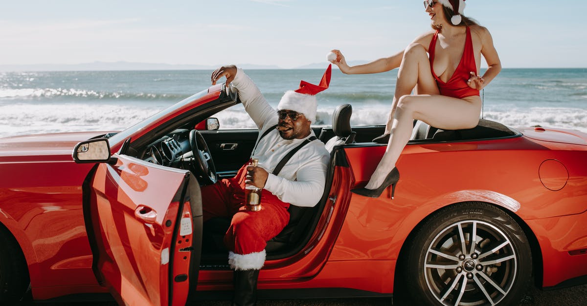 How can I put humanity on Santa's naughty list? - Man And Woman In Santa Outfits Sitting In A Red Convertible Car How can I put humanity on Santa's naughty list? - Man And Woman In Santa Outfits Sitting In A Red Convertible Car