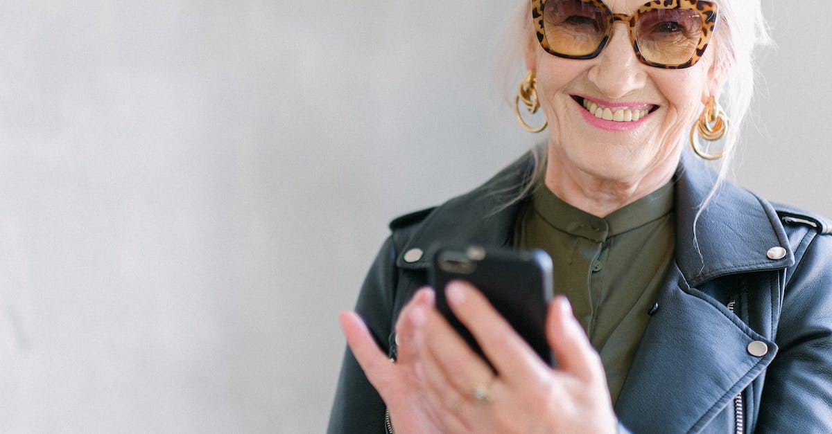 How can I "exploit" in Elder Scrolls Online and what does it do? - Crop happy senior female in stylish jacket touching screen of mobile phone while smiling and looking at camera How can I "exploit" in Elder Scrolls Online and what does it do? - Crop happy senior female in stylish jacket touching screen of mobile phone while smiling and looking at camera