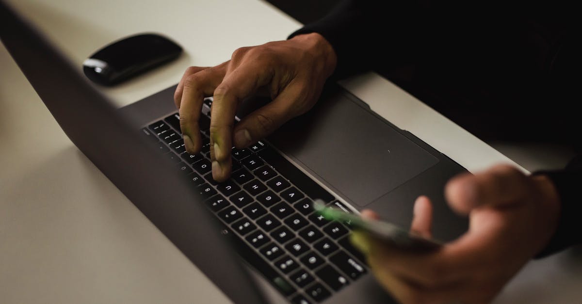 How can I remove app data from Google Play? - Crop faceless man typing on laptop and using smartphone How can I remove app data from Google Play? - Crop faceless man typing on laptop and using smartphone