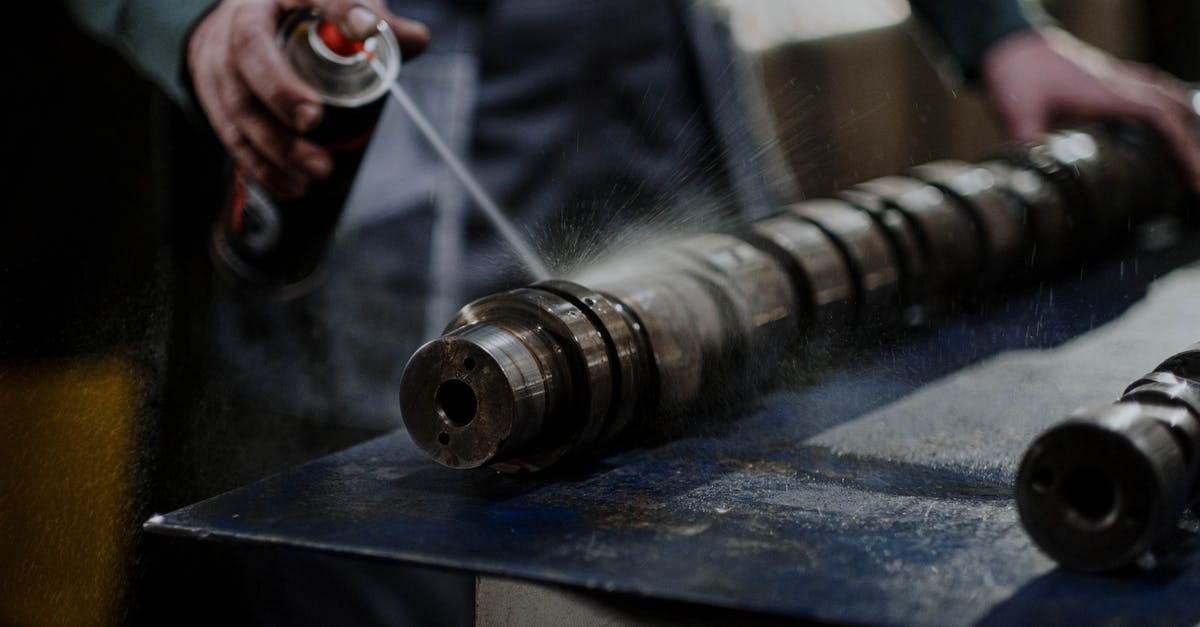 How can I repair anvils? - Person Spraying Degreaser on the Camshaft How can I repair anvils? - Person Spraying Degreaser on the Camshaft