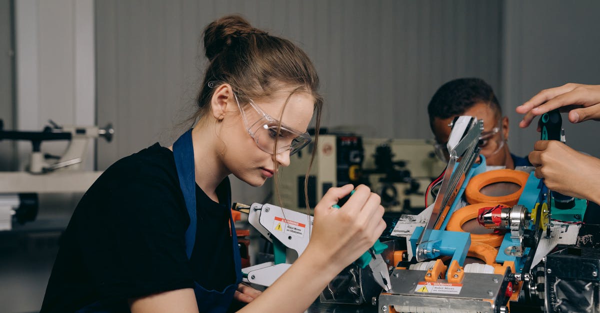 How can I safely upgrade to robot limbs in Kenshi? - A Woman in a Black Shirt Holding Pliers