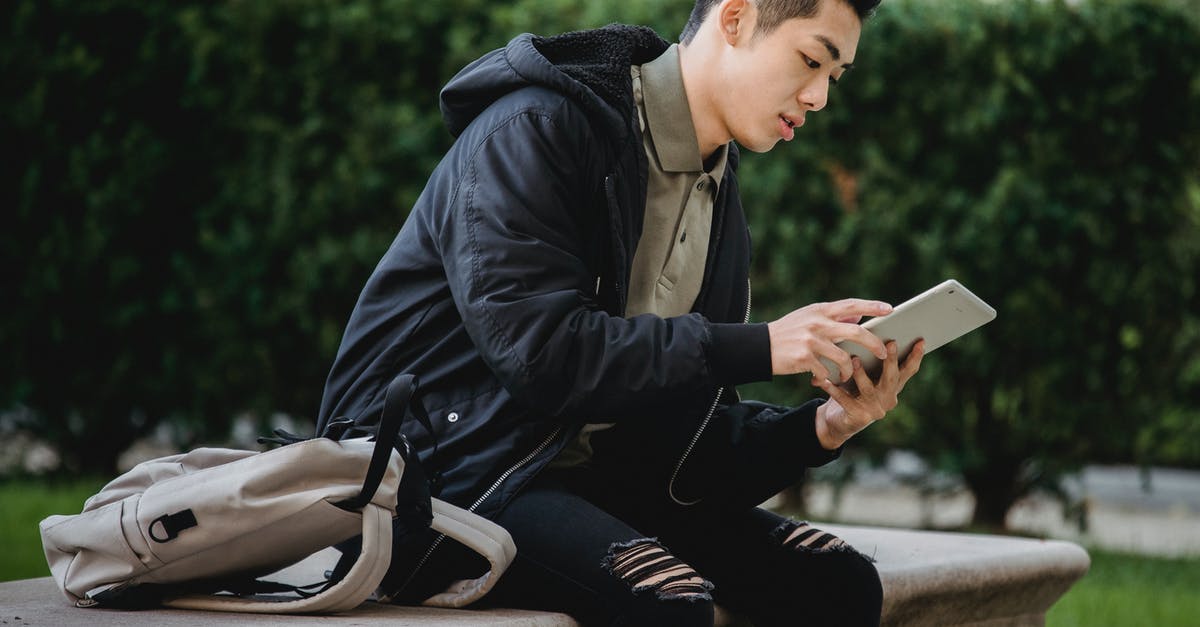 How can I scroll down to read the full item descriptions? - Serious ethnic student using tablet on bench How can I scroll down to read the full item descriptions? - Serious ethnic student using tablet on bench