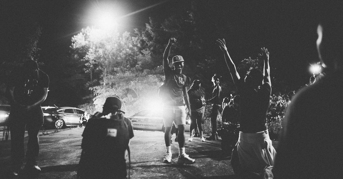 How can I show the achievements while playing? - Black and white of unrecognizable positive African American men standing on street with raised arms during film making