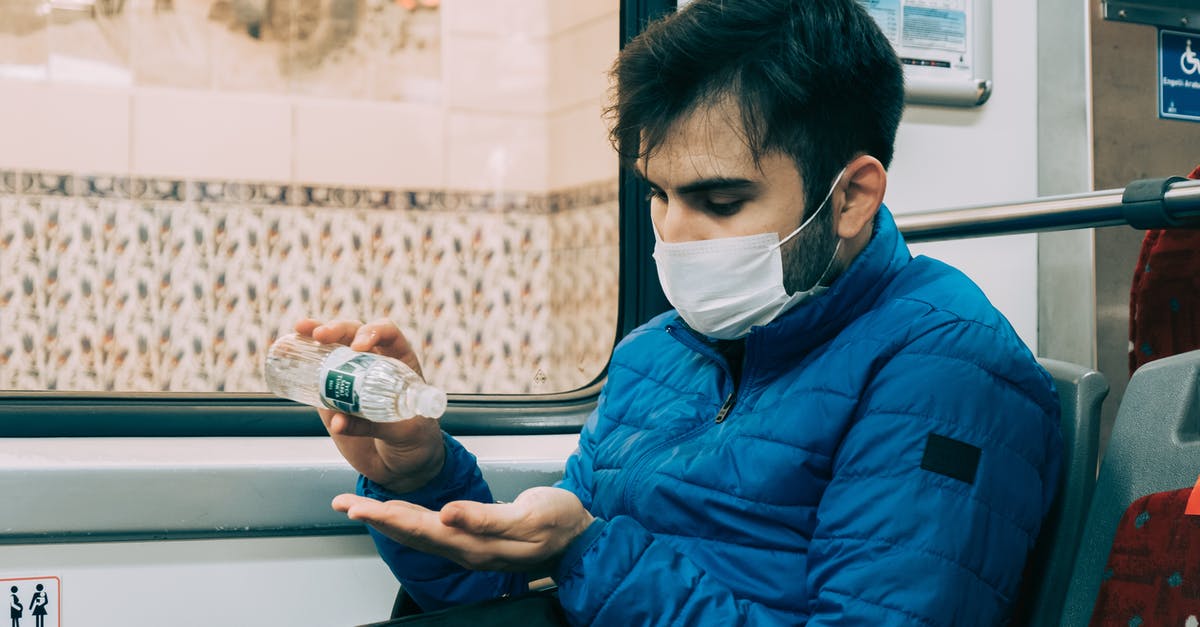How can I stop fall damage? - Man in mask applying hand sanitizer during bus trip How can I stop fall damage? - Man in mask applying hand sanitizer during bus trip