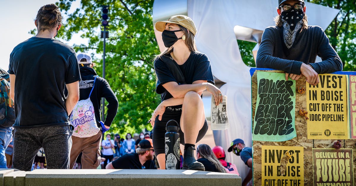 How can I stop people from living in shacks? - Group of people in masks on protest
