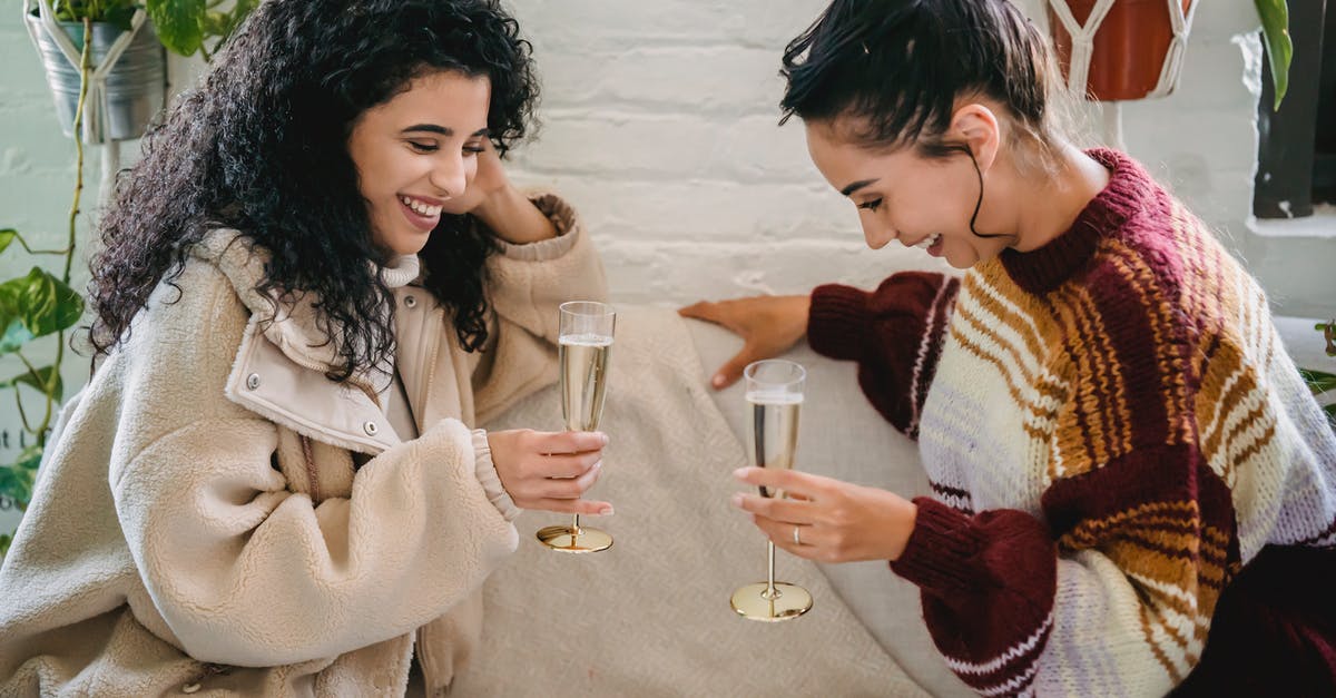 How can I tell if a side event is timed or missable? - Young happy Hispanic female friends with glasses of champagne having fun sitting on sofa and celebrating holiday