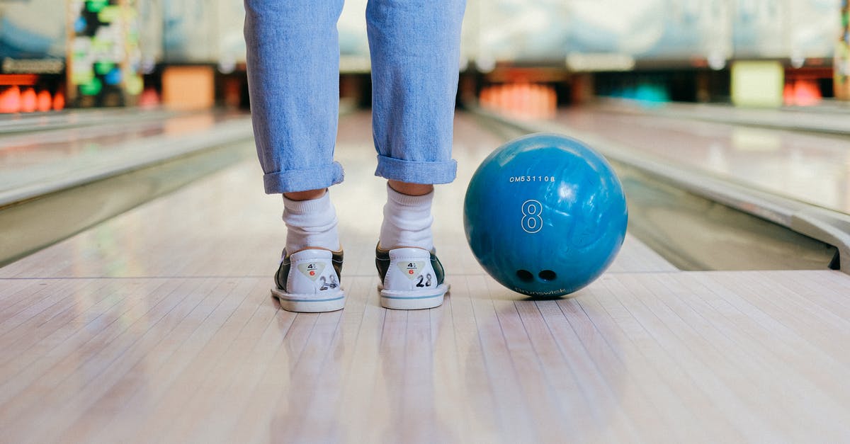 How can I tell if my game saves are backed up? - Person in Blue Denim Jeans and White Sneakers Standing on Blue Ball