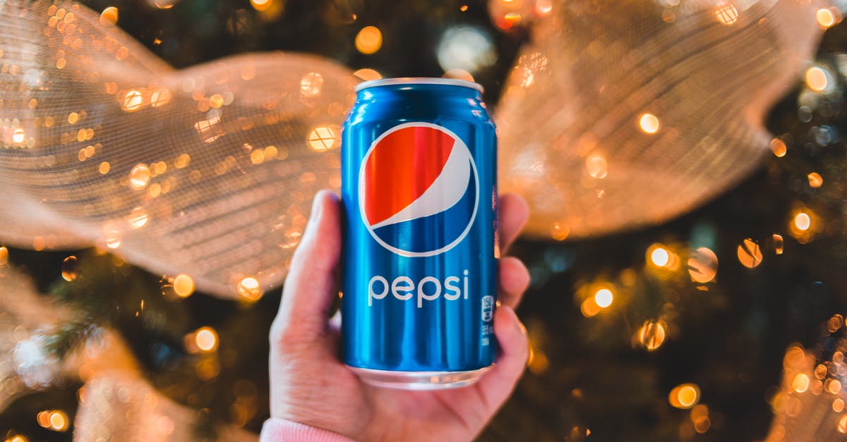 How can I tell when events end? - Crop unrecognizable person showing colorful can of refreshing drink during New Year holiday How can I tell when events end? - Crop unrecognizable person showing colorful can of refreshing drink during New Year holiday