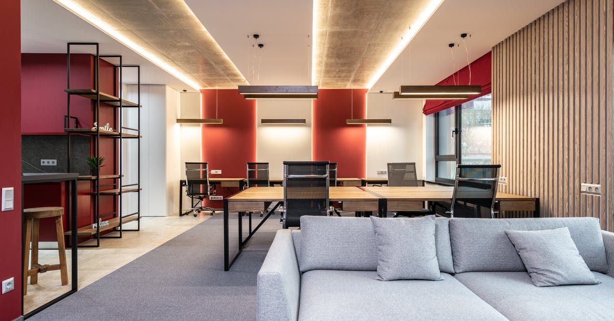 How can I tell when the Parisian Zone buildings are finished upgrading? - Lounge zone in office with couch near tables with chairs