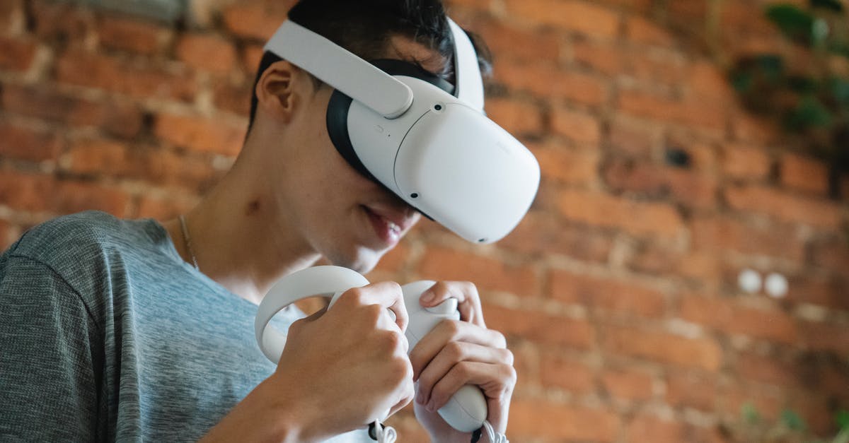 How can I use a headset for in game chat when streaming a game from my XBox One to my Windows 10 PC? - Gamer in VR headset playing video game against brick wall