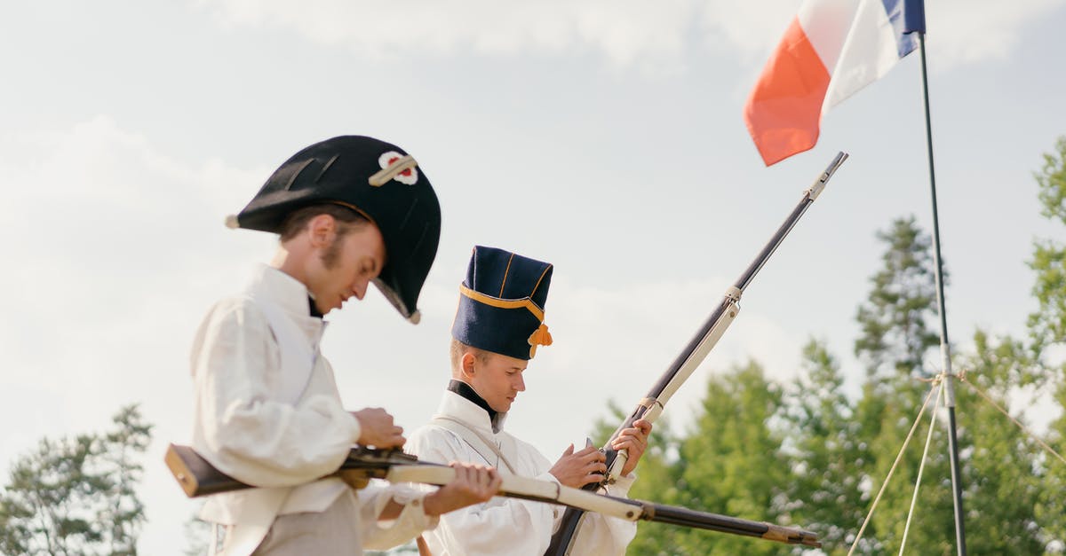 How can we force the military to kill civilians? - Soldiers charging guns near French national flag in nature How can we force the military to kill civilians? - Soldiers charging guns near French national flag in nature