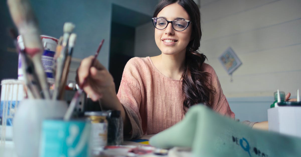 How can you control vibrotactile feedback with Rec Room circuits? - Woman in Brown Long-sleeved Shirt Wearing Eyeglasses Holding Paint Brush