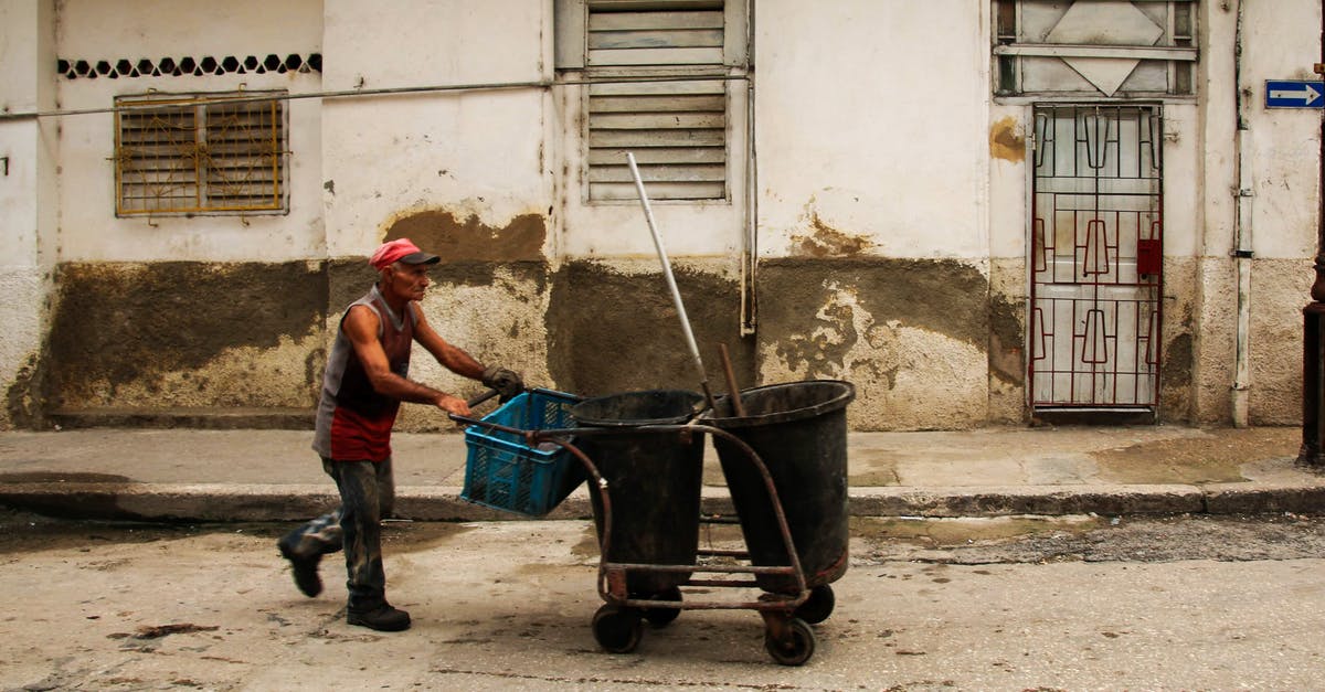 How can you tell if a crate is explosive in the Testing Area? - An Elderly Man Pushing a Cart with Trash Cans and a Plastic Crate