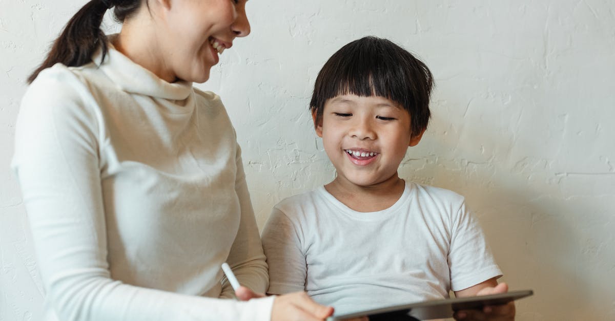 How come I can't cross Kyrat using the buzzer? - Crop ethnic mother browsing tablet with glad child How come I can't cross Kyrat using the buzzer? - Crop ethnic mother browsing tablet with glad child