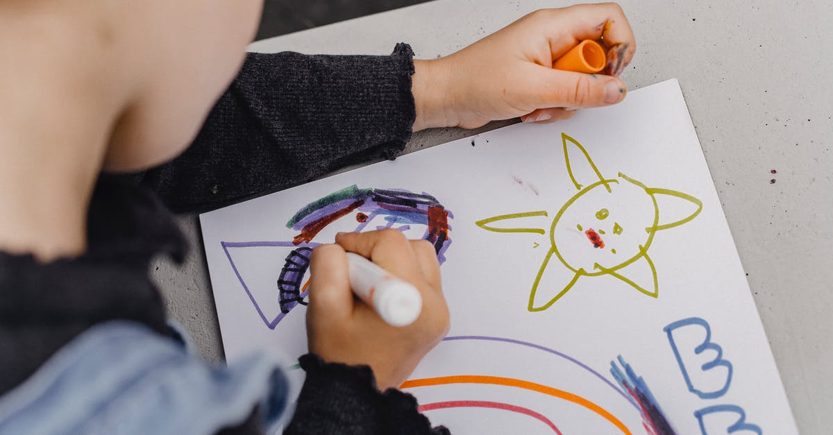 How did Cloud learn how to fight? - High angle of crop unrecognizable kid sitting at table and holding marker while painting colorful picture in album for drawing