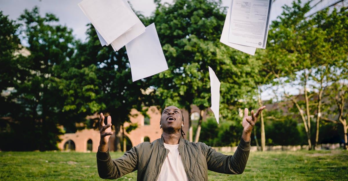 How did I get the "Unachievable" achievement? [duplicate] - Overjoyed African American graduate tossing copies of resumes in air after learning news about successfully getting job while sitting in green park with laptop