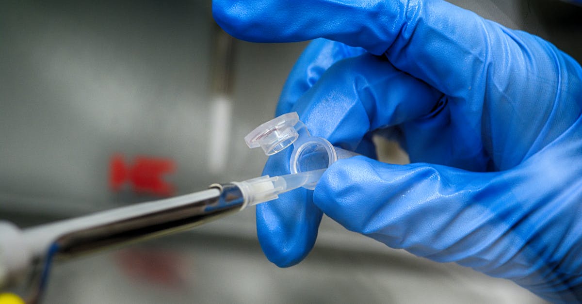 How did Liquid Snake take over the mind of Revolver Ocelot? - Crop unrecognizable scientist in blue latex gloves taking sample from plastic tube in modern laboratory How did Liquid Snake take over the mind of Revolver Ocelot? - Crop unrecognizable scientist in blue latex gloves taking sample from plastic tube in modern laboratory