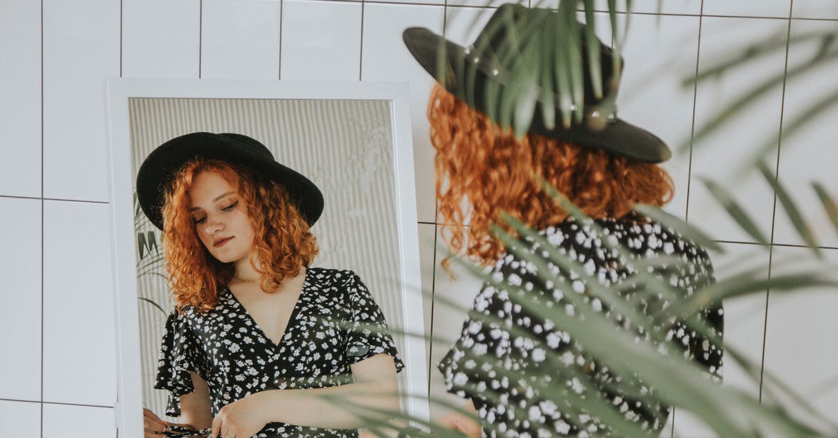 How did the Bloody Girl die? - Woman in Black and White Long Sleeve Shirt Sitting on Brown Wooden Chair