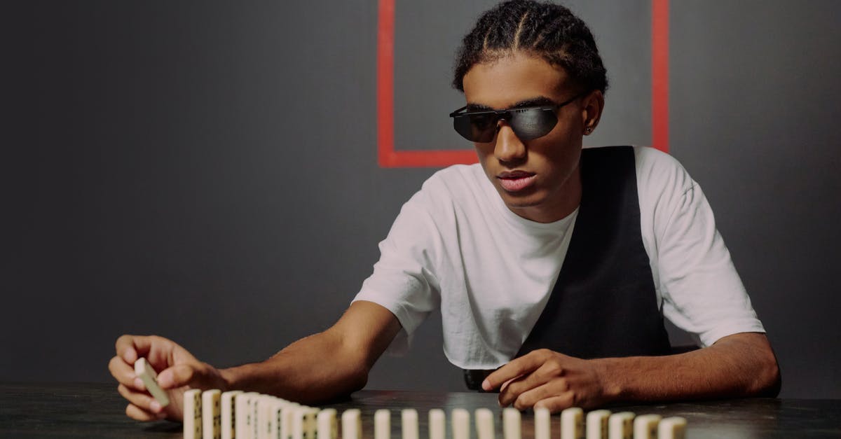 How do aim and defense stats change while taking an overwatch (reaction) shot? - Man sitting and taking one of the domino blocks