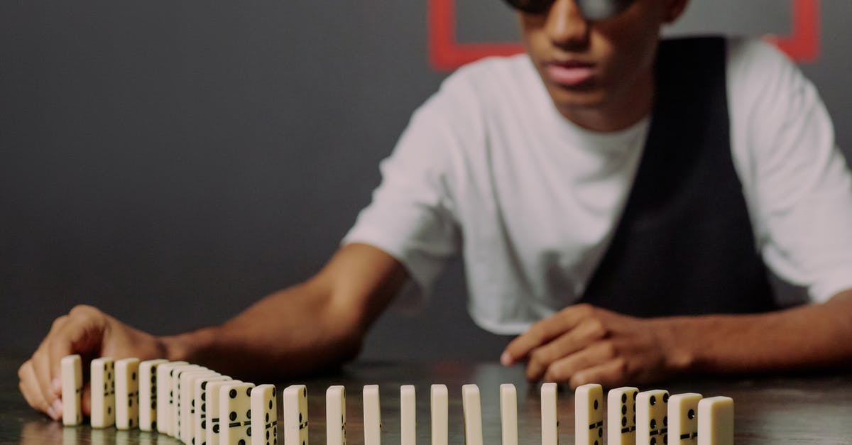 How do aim and defense stats change while taking an overwatch (reaction) shot? - Man sitting and taking one of the domino blocks