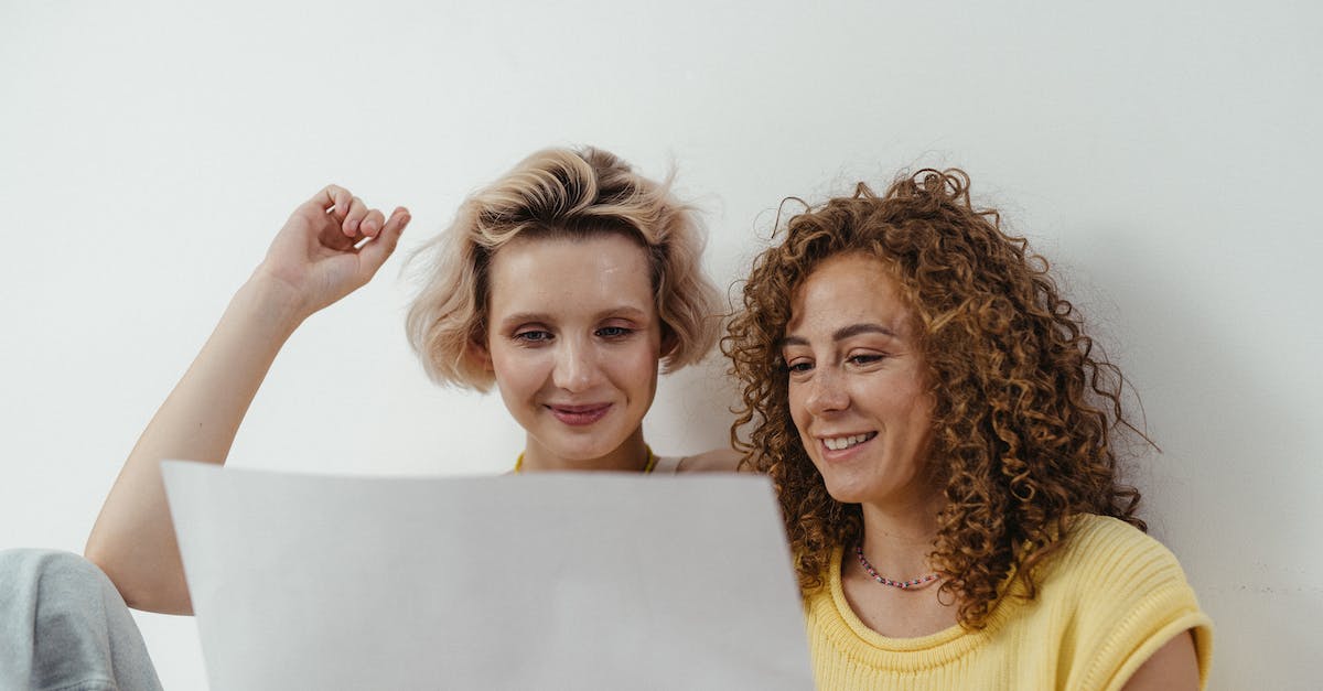 How do Badass Rank modifiers in B2 affect stats? - 2 Women Smiling While Holding White Paper