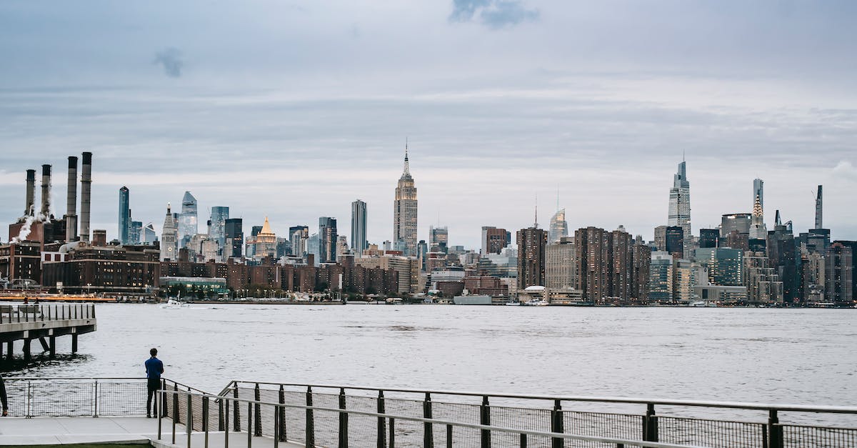 How do city states' gold investment quests work? - Man standing on embankment of river in big city How do city states' gold investment quests work? - Man standing on embankment of river in big city