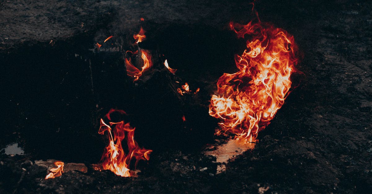 How Do Doors Keep Fire from Spreading? - High angle of bright flame forming waves in air above dark land at dusk