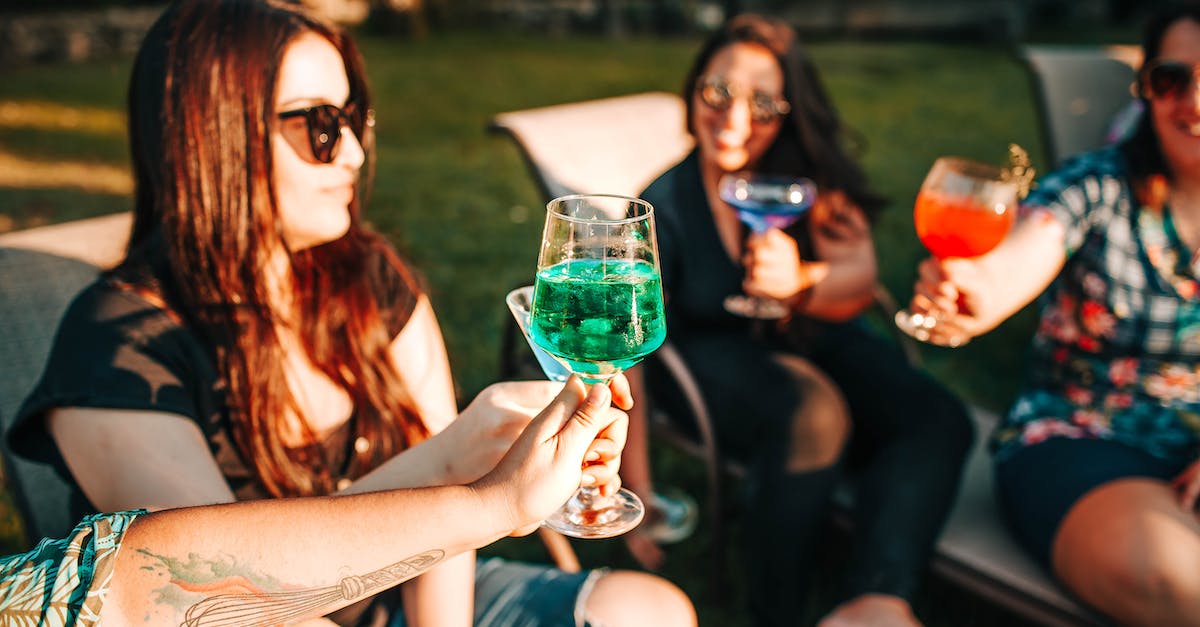 How do gang claims interact with the alcoholics group therapy program? - Smiling girlfriends in sunglasses with bright refreshing drinks sitting on sun beds near green lawn while spending time together in summer How do gang claims interact with the alcoholics group therapy program? - Smiling girlfriends in sunglasses with bright refreshing drinks sitting on sun beds near green lawn while spending time together in summer