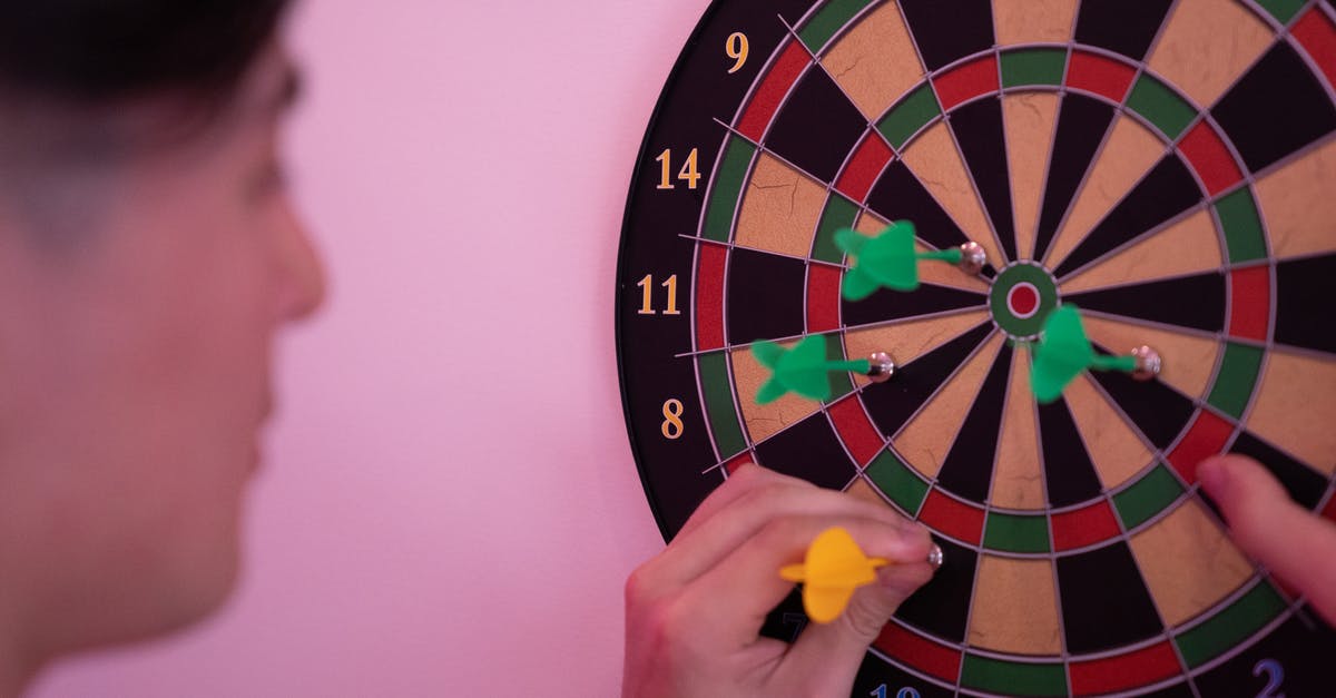 How do I achieve the 'Bullseye' achievement in Jetpack Joyride? - Person Playing Dart