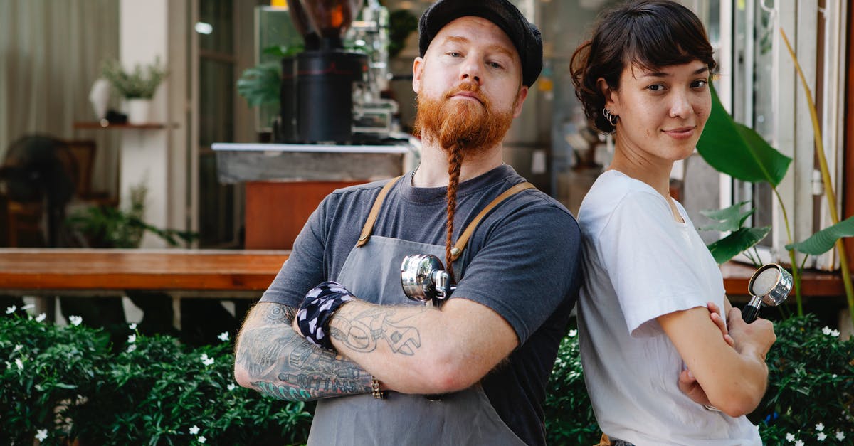 How do I activate Xbox don't starve together local coop - Couple of confident barista coworkers in aprons and casual outfit standing in street near cafeteria with portafilter near plants while looking at camera in daylight How do I activate Xbox don't starve together local coop - Couple of confident barista coworkers in aprons and casual outfit standing in street near cafeteria with portafilter near plants while looking at camera in daylight