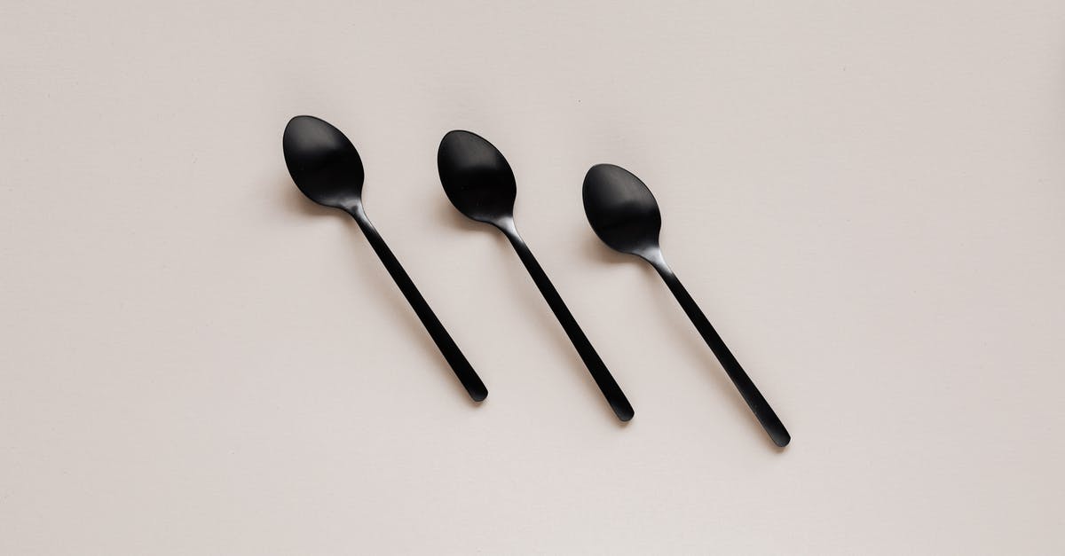 How do I add Pokemon to my team? - Set of shiny black spoons on gray table