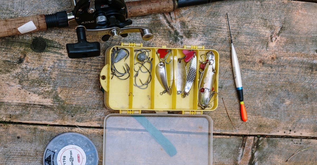How do I bait my rod? - Black and Red Fishing Rod on Brown Wooden Board How do I bait my rod? - Black and Red Fishing Rod on Brown Wooden Board