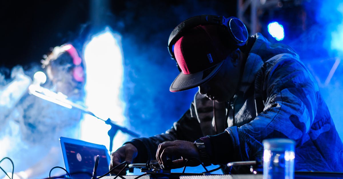 How do I beat the 'Pogo Party' minigame? - Side view of concentrated African American DJ in headphones performing music at concert in club with neon lights How do I beat the 'Pogo Party' minigame? - Side view of concentrated African American DJ in headphones performing music at concert in club with neon lights