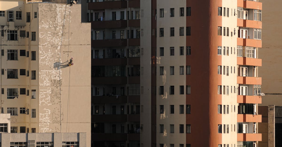 How do I block shots in FIFA 15 on PS4? - Simple multistory constructions with lots of balconies and small windows in daytime