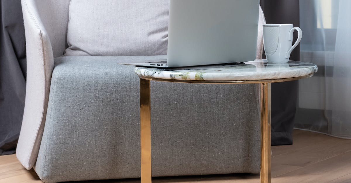 How do I break formation - Modern laptop and cup of coffee placed on small round marble table near comfortable armchair during remote work at home How do I break formation - Modern laptop and cup of coffee placed on small round marble table near comfortable armchair during remote work at home
