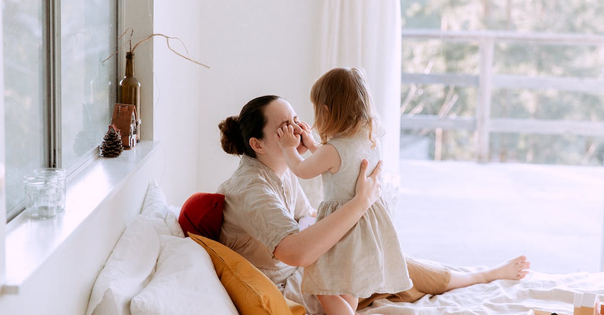 How do I break my game? - Mother and daughter having fun in bedroom while spending time together at home How do I break my game? - Mother and daughter having fun in bedroom while spending time together at home