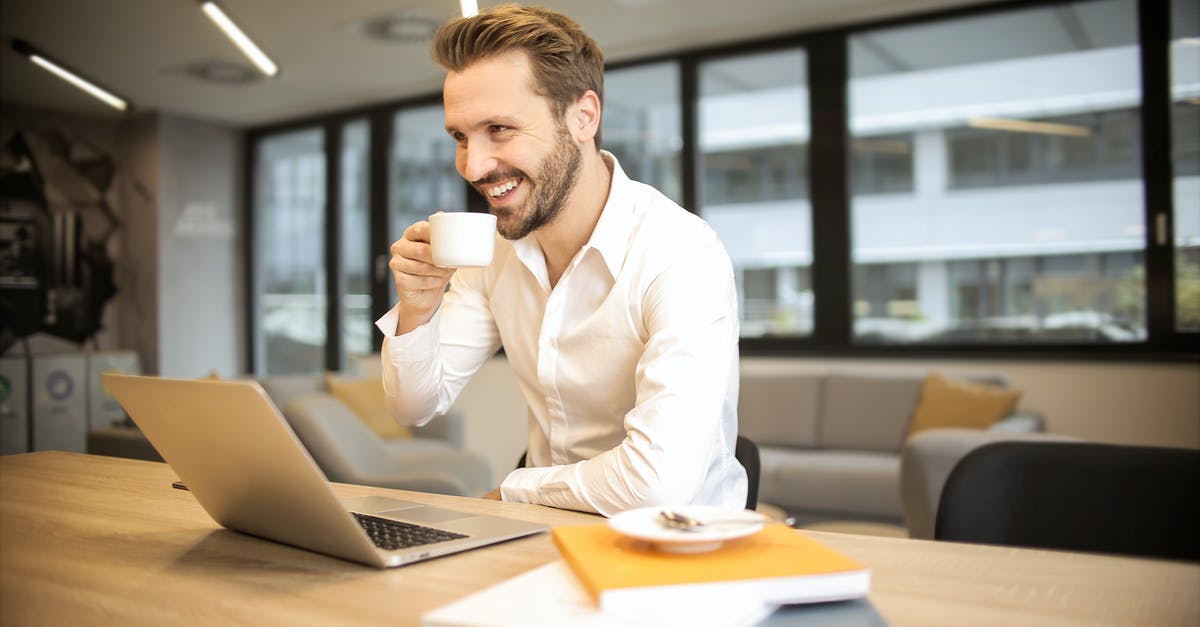 How do I break sturdy-looking rocks? - Depth of Field Photo of Man Sitting on Chair While Holding Cup in Front of Table