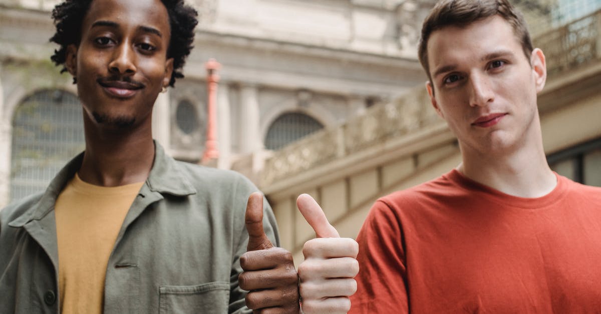 How do I build a good 'stagger lock' character? - Positive young multiracial guys demonstrating thumbs up sign at camera