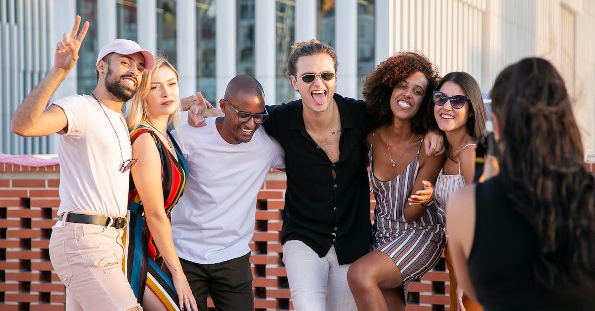 How do I capture Bari for the second time? - Faceless lady taking photo of positive diverse millennials during open air party How do I capture Bari for the second time? - Faceless lady taking photo of positive diverse millennials during open air party