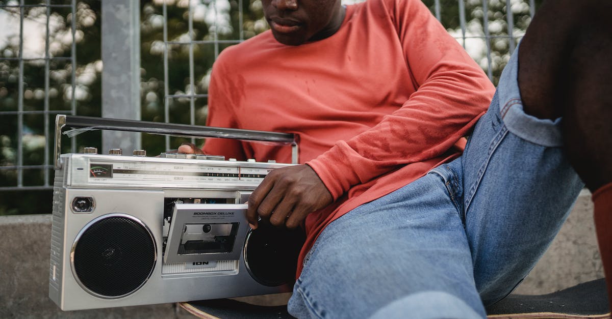 How do I change sounds on Minecraft 1.7.5? - Crop black man in casual clothes opening retro recorder to change cassette during resting on concrete surface with skateboard in city street How do I change sounds on Minecraft 1.7.5? - Crop black man in casual clothes opening retro recorder to change cassette during resting on concrete surface with skateboard in city street