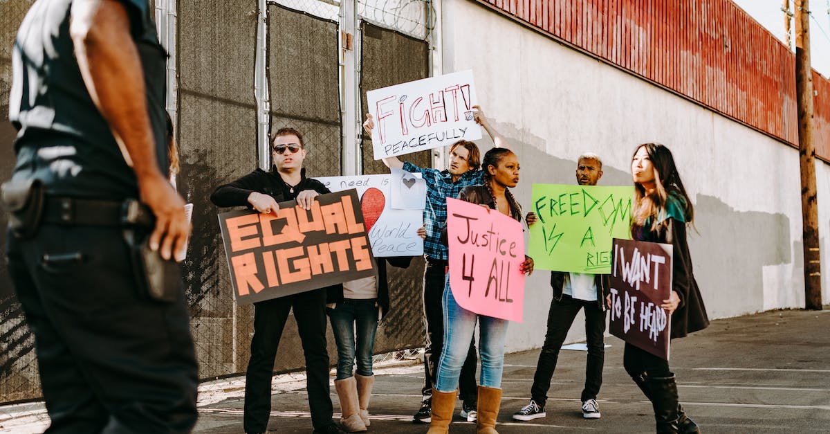 How do I change the picture on my profile? - Group of People Holding White and Pink Banner How do I change the picture on my profile? - Group of People Holding White and Pink Banner