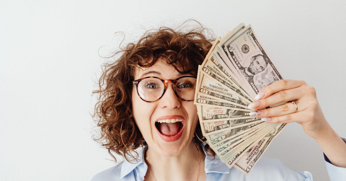 How do I change the units of measure in game? - Happy Woman in Blue Long Sleeve Blouse Holding Money