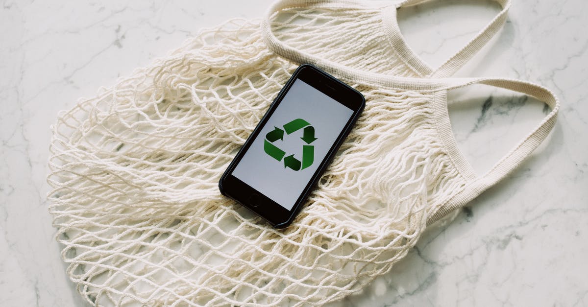 How do I cheat to remove an enemy (weretortoise) from my save file? - Overhead of smartphone with simple recycling sign on screen placed on white eco friendly mesh bag on marble table in room