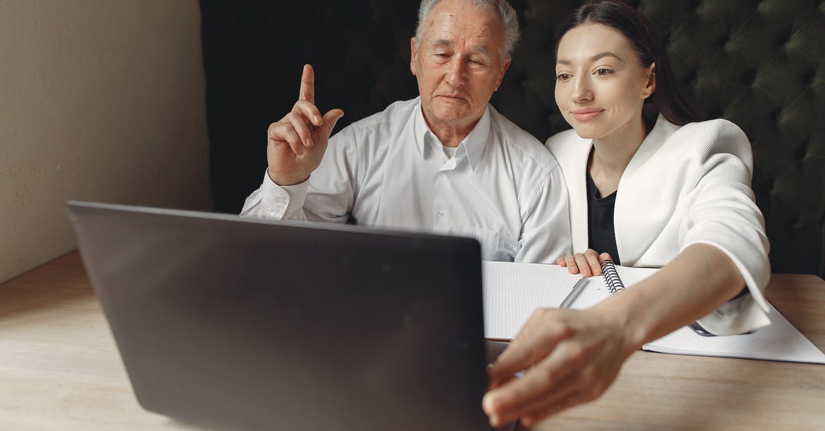 How do I check which video clips I've watched? - Positive colleagues of different aged using laptop in modern workspace How do I check which video clips I've watched? - Positive colleagues of different aged using laptop in modern workspace