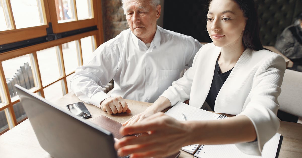 How do I check which video clips I've watched? - Positive coworkers browsing laptop in creative workspace How do I check which video clips I've watched? - Positive coworkers browsing laptop in creative workspace