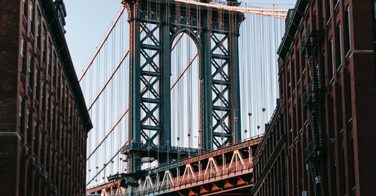 How do I clear a way point? - From below of bridge with metal heavy arch near concrete buildings under cloudless blue sky How do I clear a way point? - From below of bridge with metal heavy arch near concrete buildings under cloudless blue sky