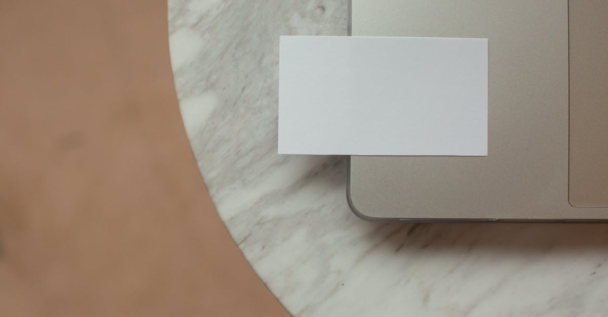 How do I clear my hotbar in Minecraft Bedrock Edition on PC? - Top view white mock up business card with copy space placed on modern opened netbook on round marble table in light room