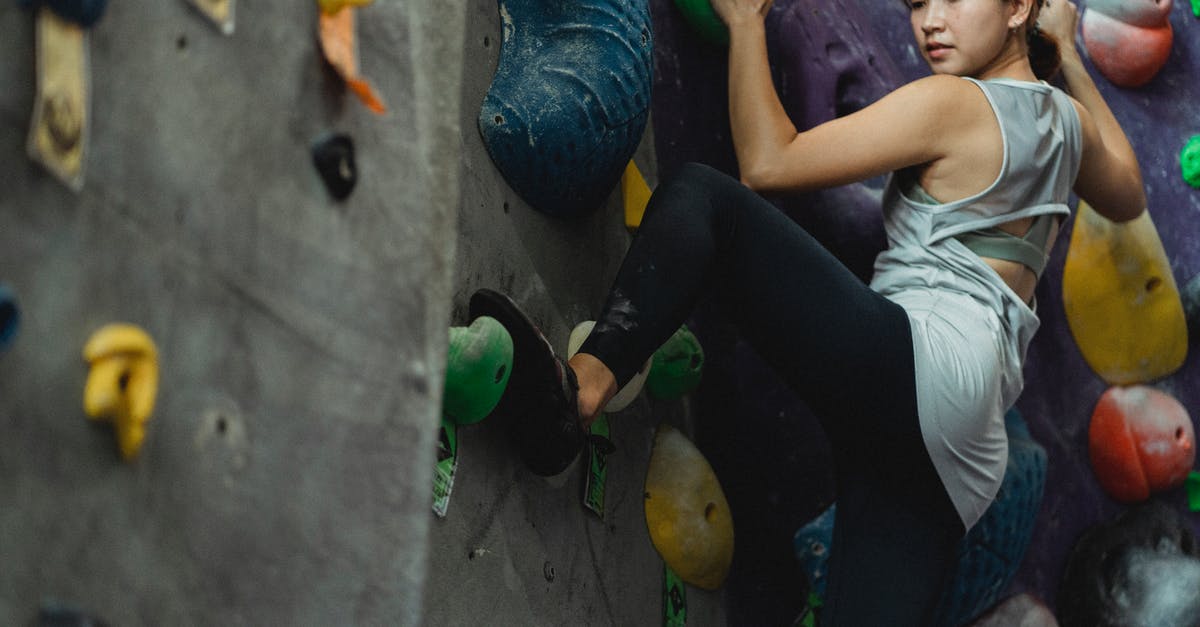 How do I climb down from the hideout in Firewatch? - Focused ethnic sportswoman climbing on wall with grips
